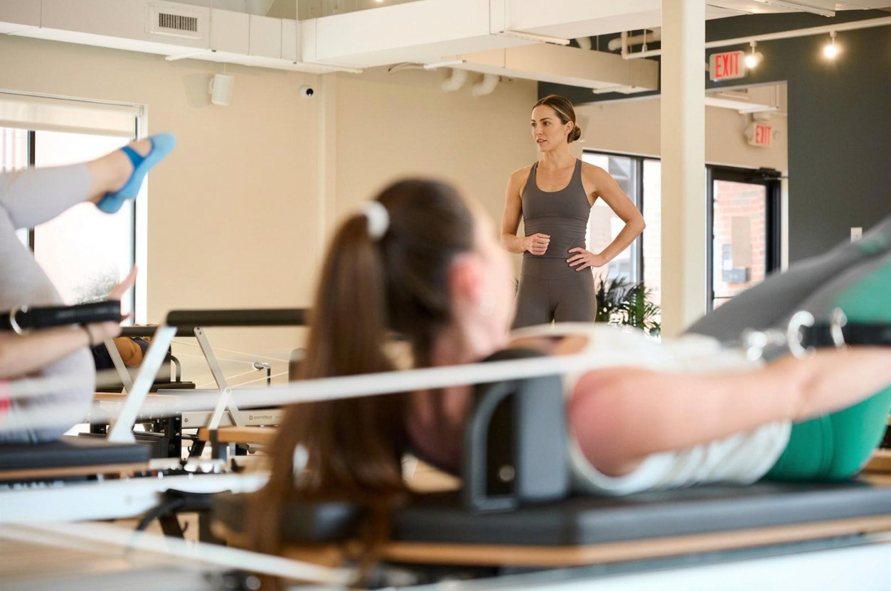 Pilates instructor teaching a small group reformer class in Chapel Hill