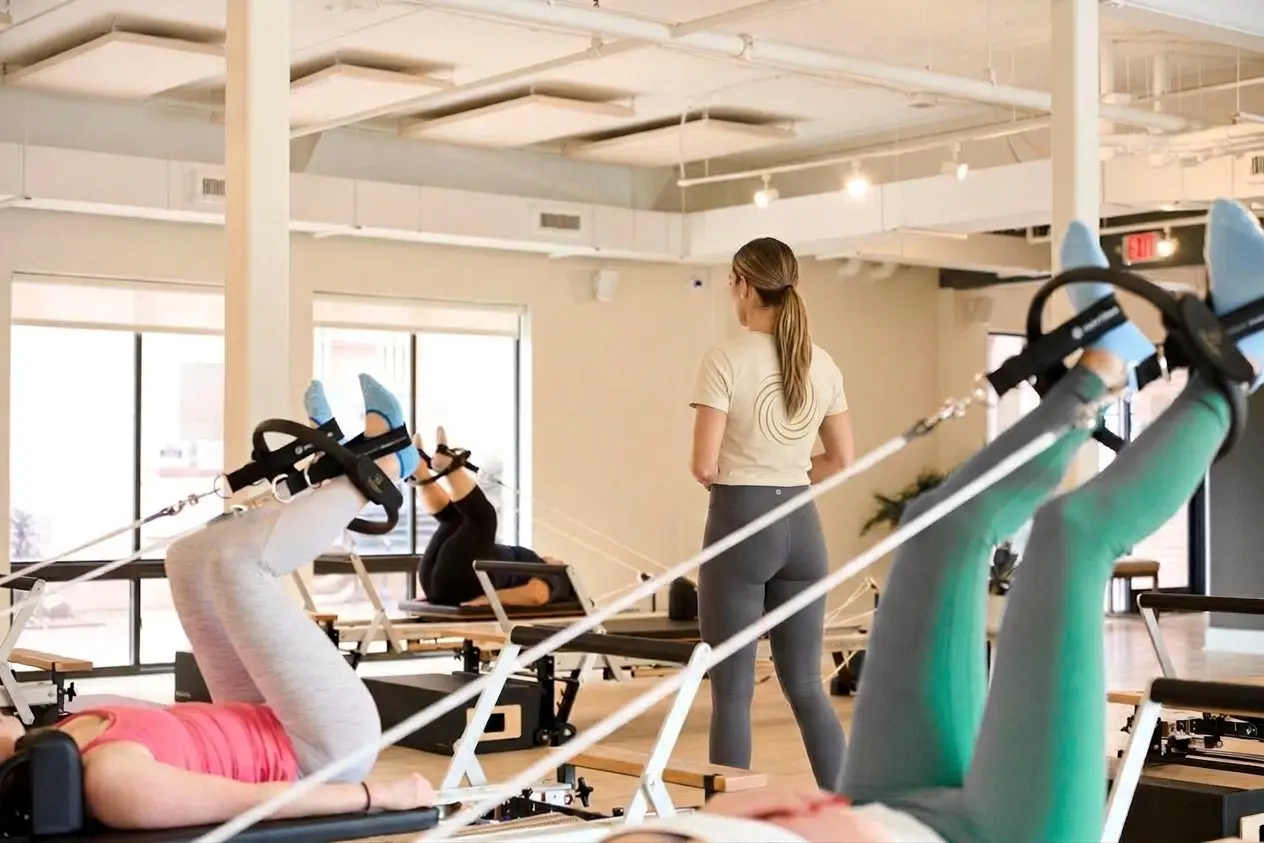 pilates instructor with branded Flow Pilates shirt